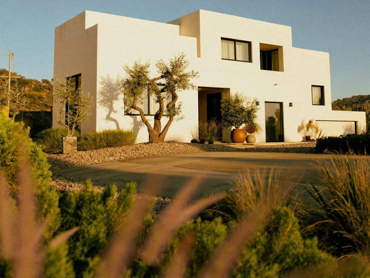 A modern white California home at golden hour, financed through a mortgage broker