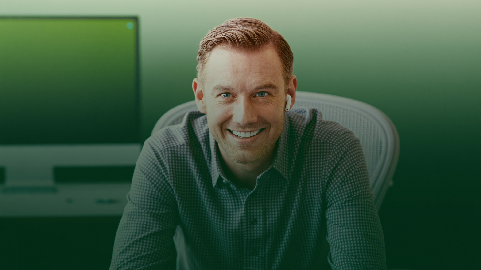 A California mortgage broker at S.O.S. Loans smiling at his desk
